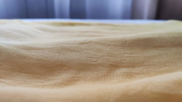 Abstract background and texture from yellow linen fabric, made from linen fiber