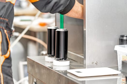 beer filled beverage cans in a brewery.