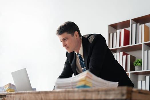 Young businessman working with laptop at office.