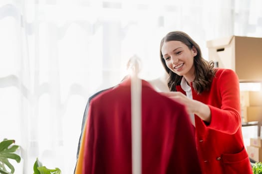 young woman work for checking the clothes in the home, concept e commerce...