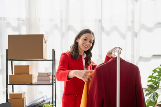 young woman work for checking the clothes in the home, concept e commerce...