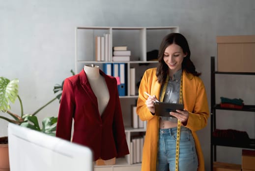 Portrait of young beautiful asian woman fashion designer stylish stand and working with color samples.Attractive young asian girl working with colorful