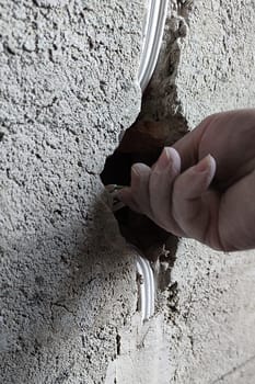 installation of an electrical outlet in a concrete wall close up