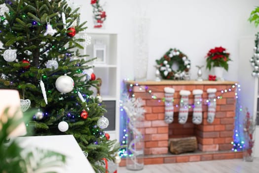 Christmas living room with fireplace and decorations. Christmas tree with baubles.