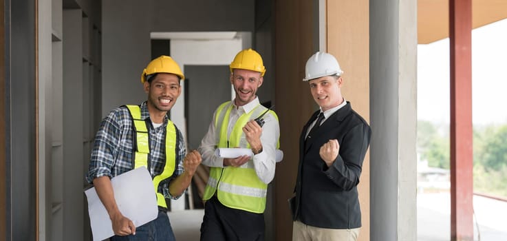 Civil engineer teams meeting working together wear worker helmets hardhat on construction site in modern city. Foreman industry project manager engineer teamwork. Asian industry professional team...