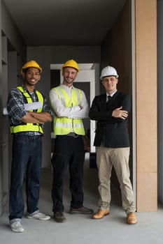 Civil engineer teams meeting working together wear worker helmets hardhat on construction site in modern city. Foreman industry project manager engineer teamwork. Asian industry professional team...