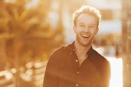 Beautiful nature. Young man is outdoors at sunny daytime. Concept of vacation.