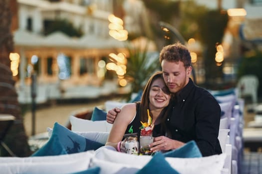 Closeness of the people. Happy young couple is together on their vacation. Outdoors at sunny daytime.