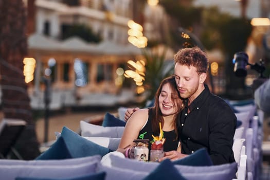 Closeness of the people. Happy young couple is together on their vacation. Outdoors at sunny daytime.