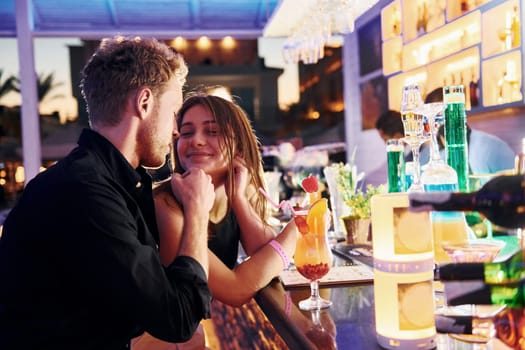 At the bar. Happy young couple is together on their vacation.