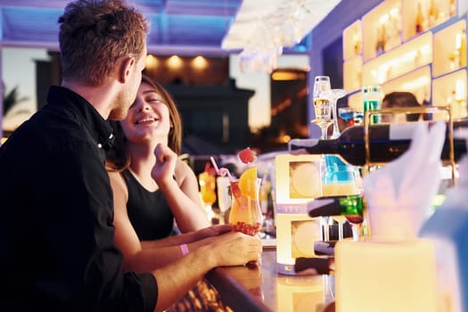 At the bar. Happy young couple is together on their vacation.