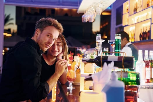 At the bar. Happy young couple is together on their vacation.