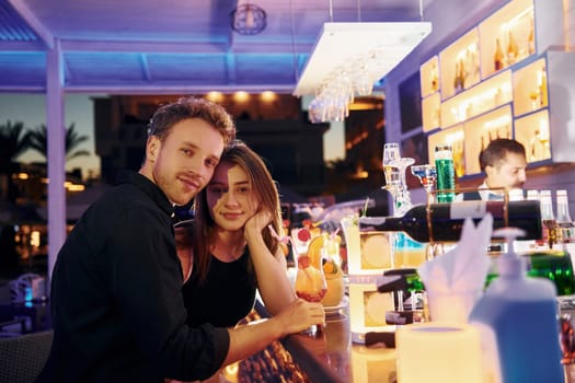 At the bar. Happy young couple is together on their vacation.