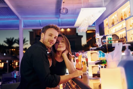At the bar. Happy young couple is together on their vacation.