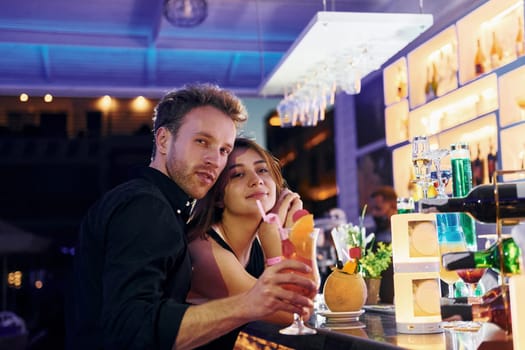 At the bar. Happy young couple is together on their vacation.