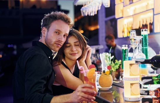 At the bar. Happy young couple is together on their vacation.