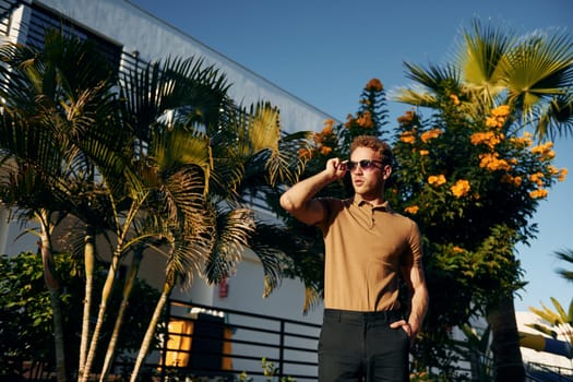 Beautiful nature. Young man is outdoors at sunny daytime. Concept of vacation.