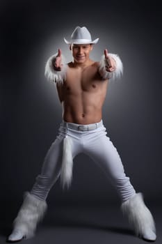 Full length portrait of sexy dancer in white cowboy costume