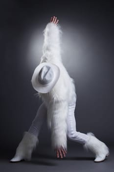 Studio portrait of sexy dancer in white cowboy costume