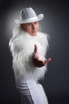 Studio portrait of sexy dancer in white fur costume