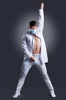 Dancer in white doctor costume. Studio portrait