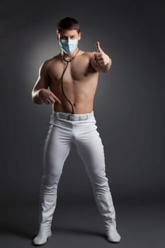 Young sexy dancer in doctor costume. Studio portrait