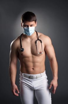 Sexy dancer in doctor costume with stethoscope. Studio portrait