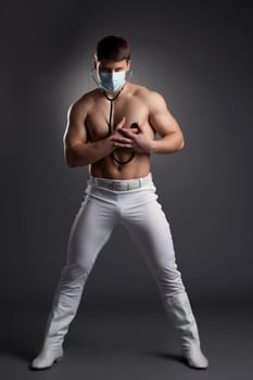 Sexy dancer in white doctor costume. Studio portrait