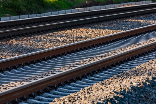 Two parallel tracks with rails, sleepers and wires