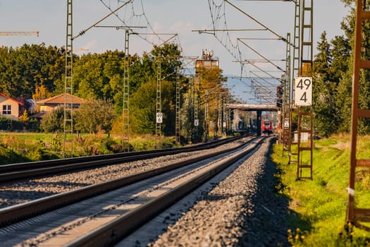 Straight track layout and rails with a bridge and track bed with ballast and overhead wires