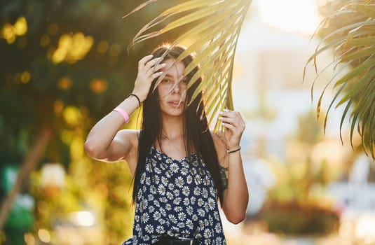 Beautiful young woman is outdoors at sunny daytime. Concept of vacation.