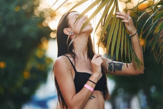 In bra. Beautiful young woman is outdoors at sunny daytime. Concept of vacation.