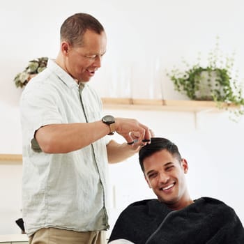 Father, man and shaving hair in home for grooming, cleaning and trimming. Smile, laughing and happy male or son getting haircut with electric shaver from senior dad for hairstyle and bonding in house.