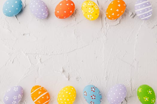 Easter Day Concept. Top view holiday banner background web design white colorful easter eggs painted on white cement background with empty copy space, celebration greeting card, overhead, template