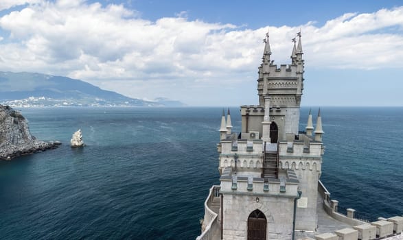 Aerial view of Swallow's Nest castle on the rock in Black Sea. It is a symbol and landmark of Crimea. Beautiful scenic panorama of the Crimea coast. Amazing Swallow's Nest at the precipice.