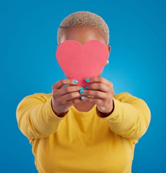 Paper, heart and cover with black woman in studio for love, date and kindness. Invitation, romance and feelings with female and shape isolated on blue background for emotion, support and affectionate.
