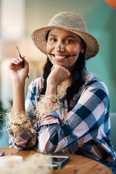 Unleashing my inner scarecrow. a young woman applying halloween makeup at home