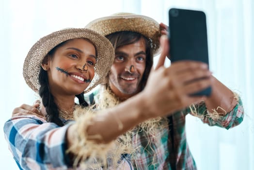 I think we look pretty good. a young couple taking a selfie at a party