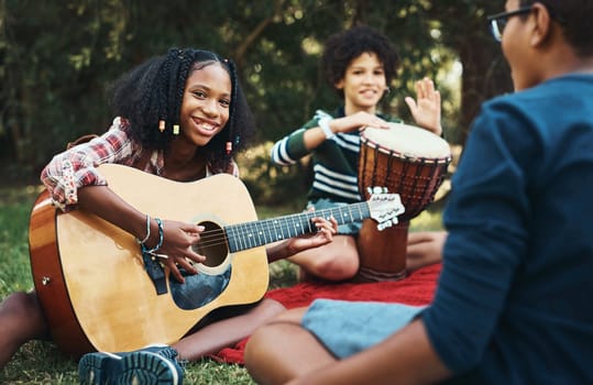 Every summer camp has a soundtrack. a group of teenagers playing musical instruments in nature at summer camp