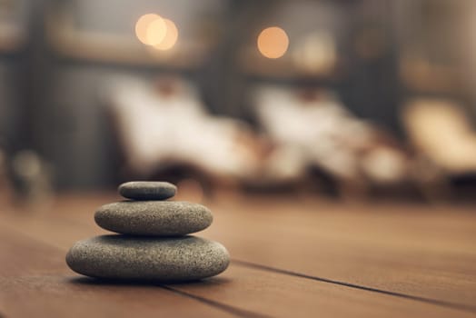 Treat yourself to a spa experience. three stones balanced on top of each other in a spa