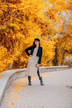 A woman walks outdoors in autumn, enjoys the autumn weather