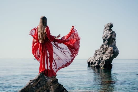 Woman travel sea. Happy tourist taking picture outdoors for memories. Woman traveler looks at the edge of the cliff on the sea bay of mountains, sharing travel adventure journey.