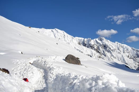 Snow-covered Kedarnath temple route in Himalaya. Kedarnath is a town in the Indian state of Uttarakhand and has gained importance because of Kedarnath Temple.