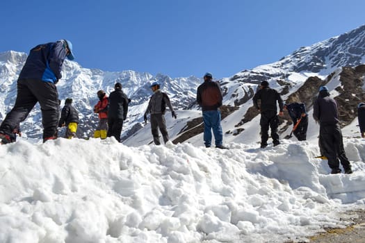Rudarprayag, Uttarakhand, India, April 26 2014, laborer opening the snow-covered Kedarnath temple route. Kedarnath is a town in the Indian state of Uttarakhand and has gained importance because of Kedarnath Temple.