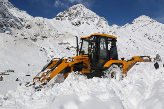 Rudarprayag, Uttarakhand, India, September 09 2014, JCB machine working in snowfall in kedarnath reconstruction. Government made a reconstruction plan for the Kedarnath temple area that was damaged in floods of 2013.