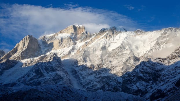 Snow covered mountain peaks of Himalaya in India. The Himalayas, or Himalaya, is a mountain range in Asia separating the plains of the Indian subcontinent from the Tibetan Plateau.