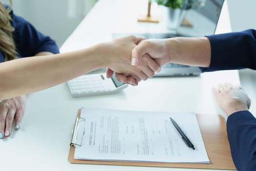 Asian entrepreneurs handshakes to congratulate the agreement between the two companies to enhance investment and financial strength. deal concept.