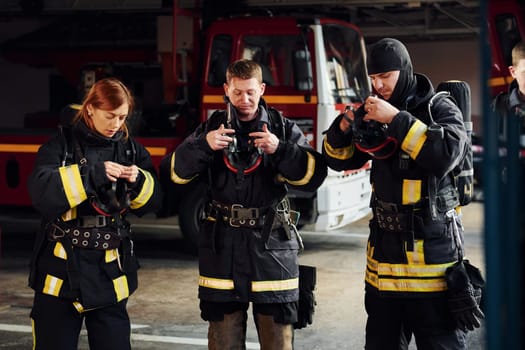 Wearing protective uniform. Group of firefighters that is on station.