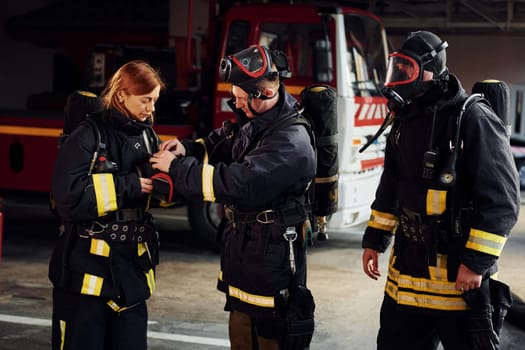 Wearing protective uniform. Group of firefighters that is on station.
