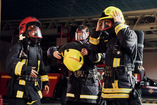 Wearing protective uniform. Group of firefighters that is on station.